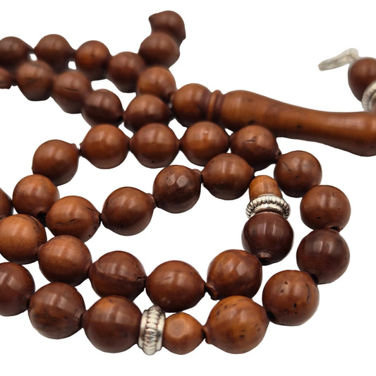 Nature’s resilience in your hand. Carved from the ultra-dense shell of the Narjil (Coconut) Fruit, these beads are renowned for their rugged durability and unique, earthy grain