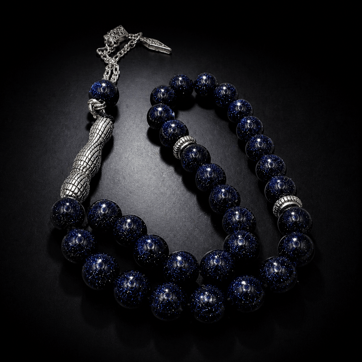 Dark Goldstone tasbih, the chain fastening and tassel end — goldstone for ambition