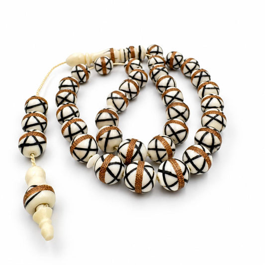 Camel bone misbaha close-up, copper-tone wire bands on white beads — handcrafted sebha UAE