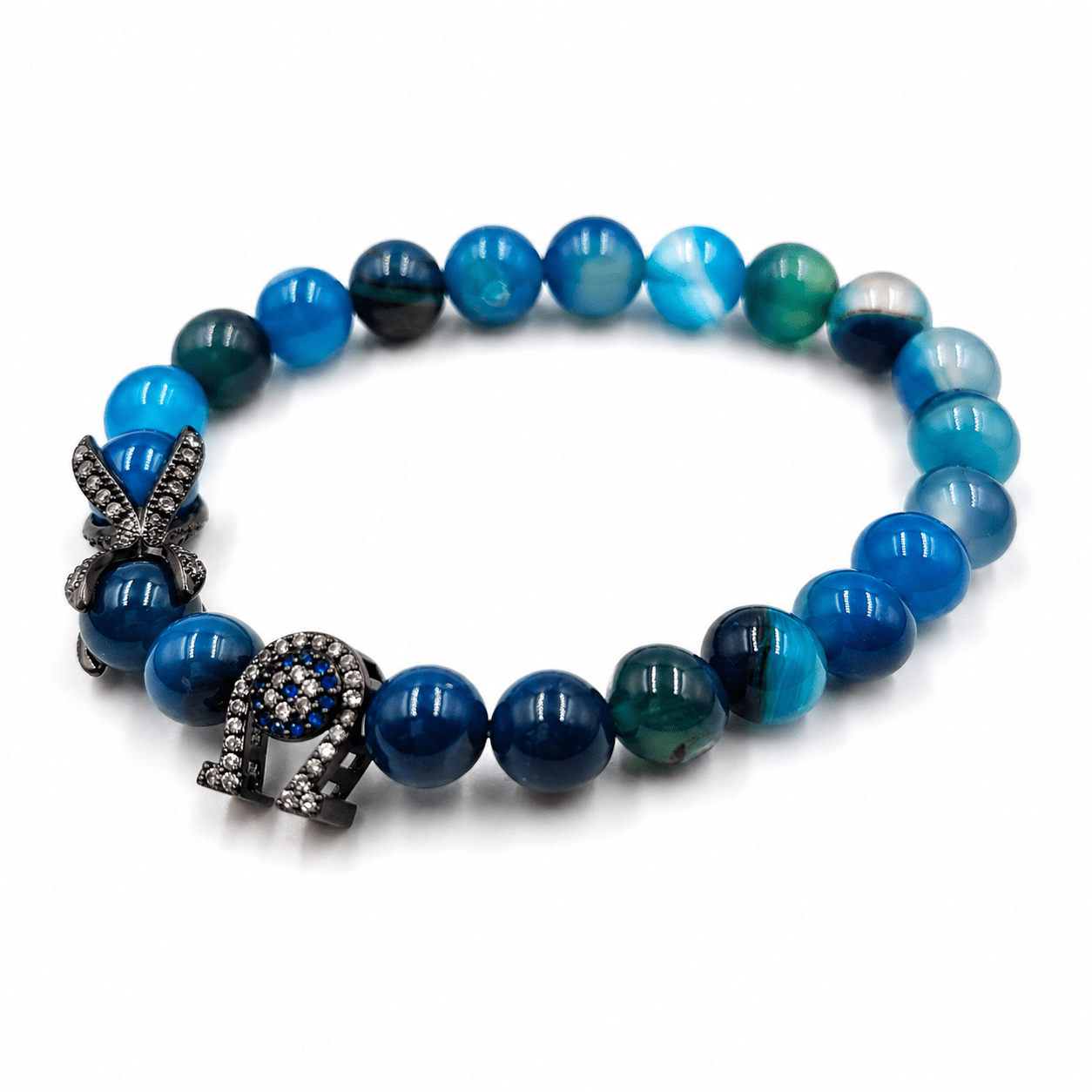 Black and Blue Agate bracelet, on the wrist beside the cuff — black and blue agate for clarity
