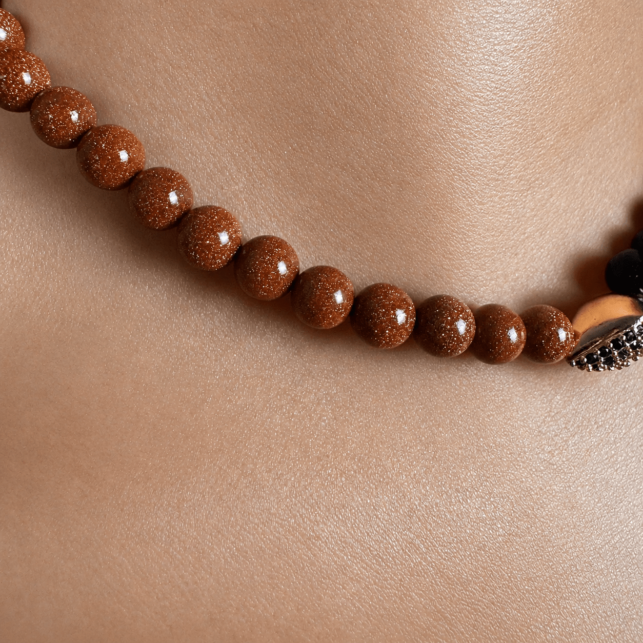 Brown and Dark Goldstone necklace and bracelet set on a white background — brown and goldstone for ambition