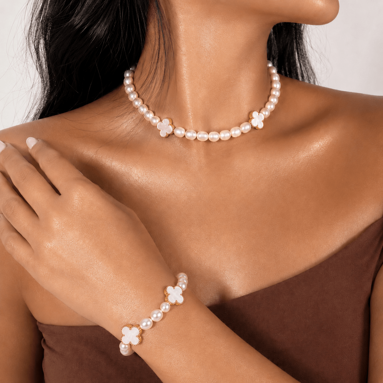 White Freshwater Pearl necklace and bracelet set, on the wrist against a neutral ground — white freshwater pearl for peace
