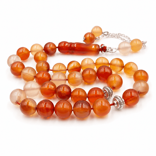 Orange Agate sibha held in hand showing bead size — buy orange agate beads UAE