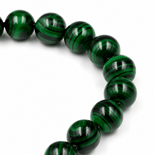 Malachite sibha held in hand showing bead size — buy malachite beads UAE