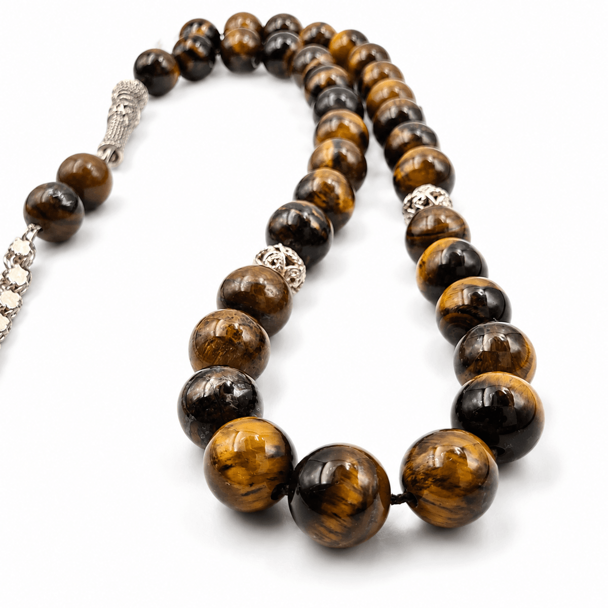 Golden Tiger Eye tasbih, the tassel against the final bead — golden tiger eye for protection