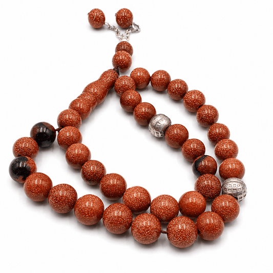 Brown Goldstone misbaha held in hand showing bead size — buy brown goldstone beads UAE