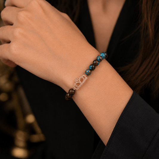 Red Tiger Eye and Blue Crystal bracelet, on the wrist beside the cuff — red tiger eye and blue crystal for ambition