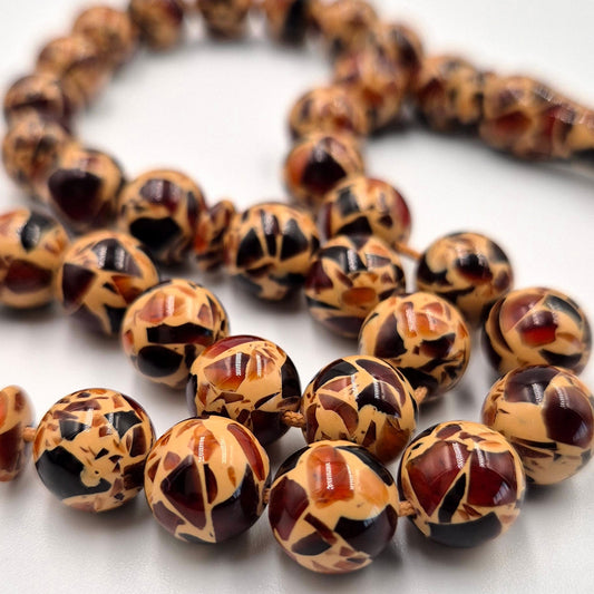 Tiger Skin Miski misbaha, close detail of banded amber-toned beads — buy tiger skin miski beads UAE