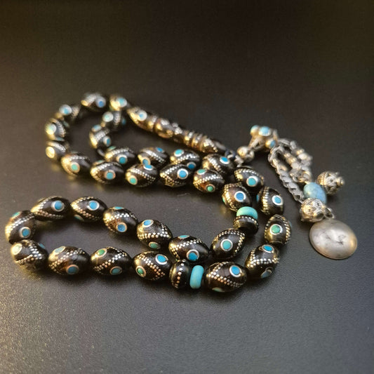 Fairouza Yusr sebha, close detail of Fairouz turquoise eyes in silver inlay — buy yusur wood beads UAE