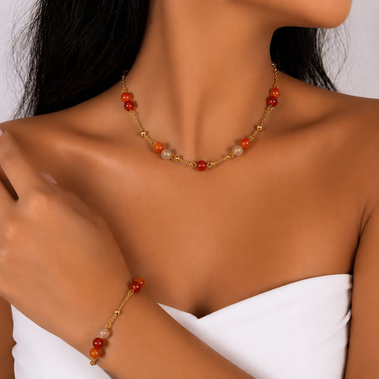Orange Agate gold-plated silver chain necklace and bracelet set, on the wrist beside the cuff — orange agate for vitality
