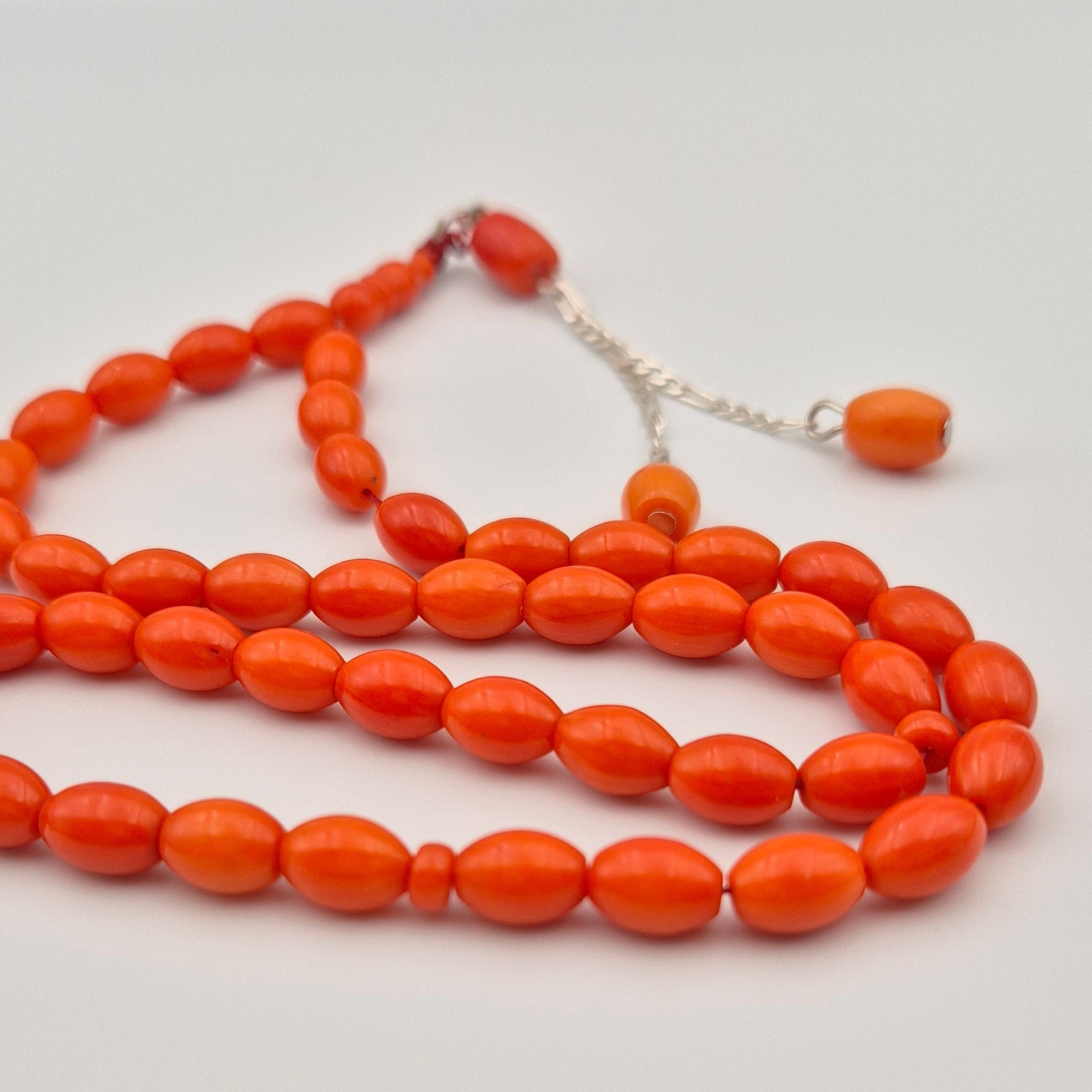 Experience the smooth, tactile glide of our exclusive 33-bead Laseric coral arrangement. Featuring a classic barrel cut and premium sterling silver chain for a distinctly heavy, luxurious feel. One-time artifact.