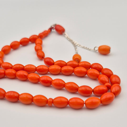 Experience the smooth, tactile glide of our exclusive 33-bead Laseric coral arrangement. Featuring a classic barrel cut and premium sterling silver chain for a distinctly heavy, luxurious feel. One-time artifact.