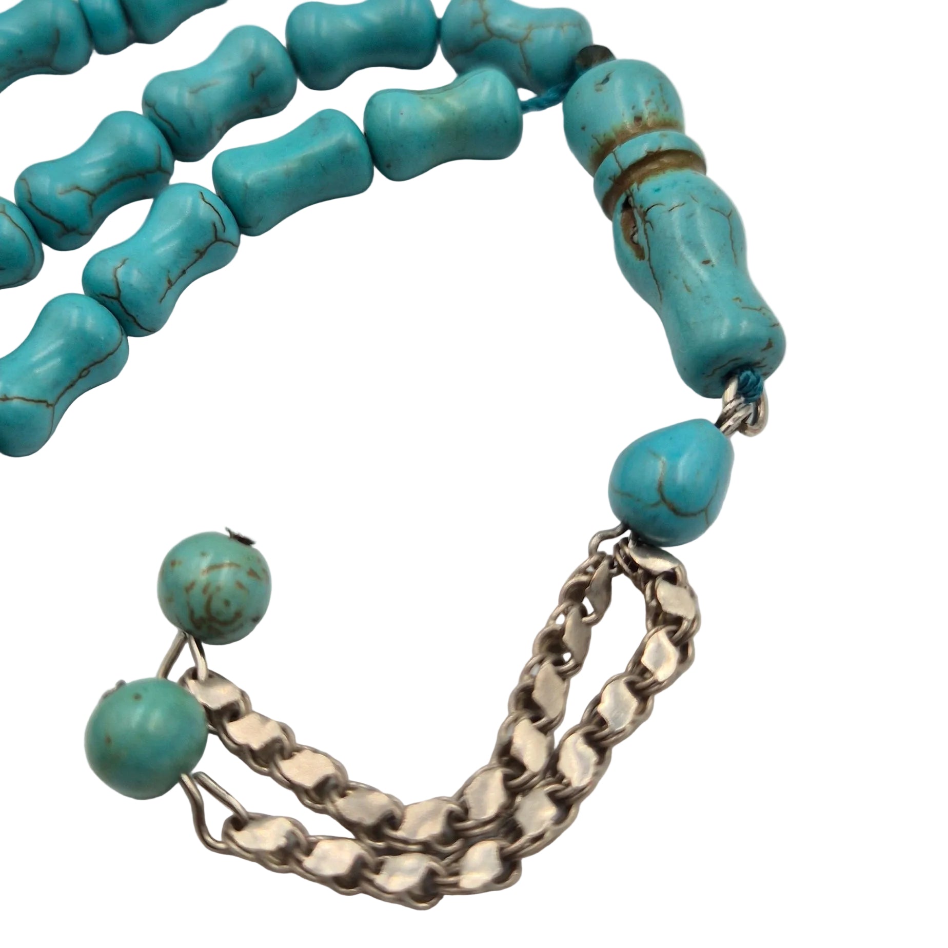 Turquoise beaded necklace with a silver chain on a light gray background