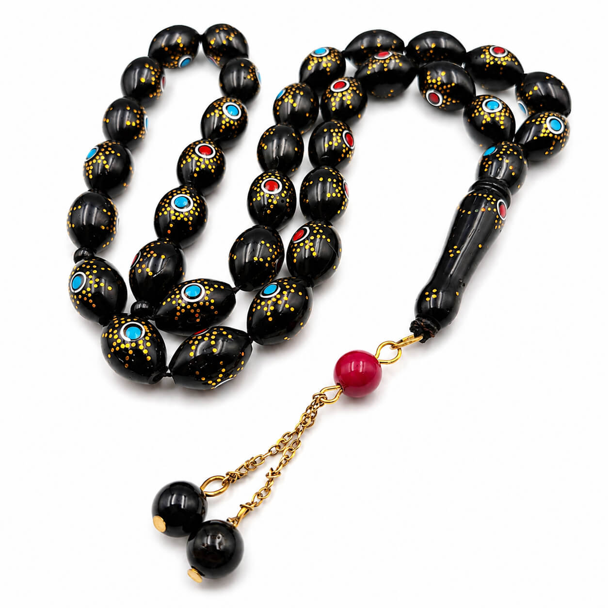 Sun Eye Kuka sibha, the tassel coiled beside the strand — kuka beads