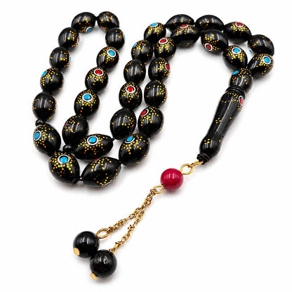 Sun Eye Kuka sibha, the tassel coiled beside the strand — kuka beads