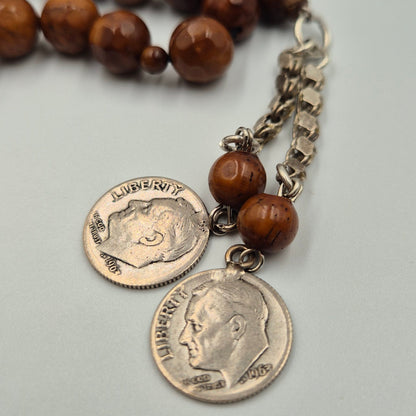 Carved from the resilient Narjil (Coconut) Shell, this tasbih combines organic warmth with metallic precision. Each bead is inlaid with striking Silver-Tone with Red and Blue Craftings.