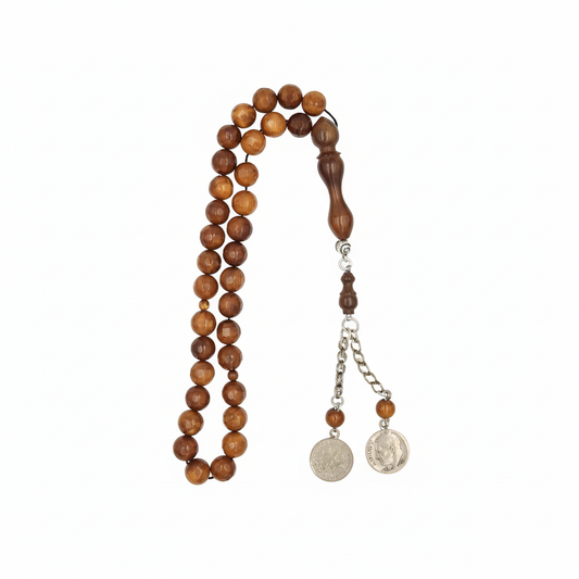 Carved from the resilient Narjil (Coconut) Shell, this tasbih combines organic warmth with metallic precision. Each bead is inlaid with striking Silver-Tone with Red and Blue Craftings.