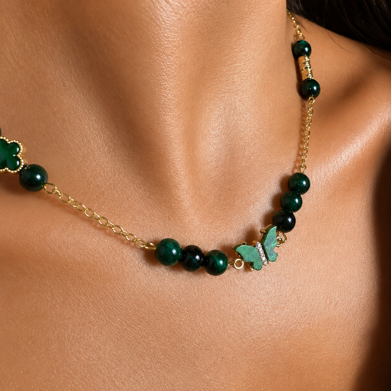   Green Tiger Eye gold-plated silver chain necklace and bracelet set on white background
