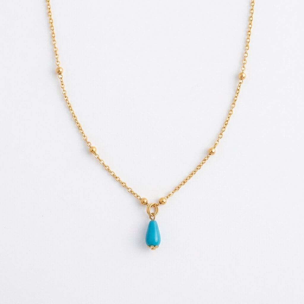 Silver gold-plated Fairouz teardrop necklace on a satellite chain, turquoise pendant on white — Fairouz necklace UAE