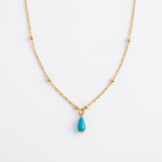 Silver gold-plated Fairouz teardrop necklace on a satellite chain, turquoise pendant on white — Fairouz necklace UAE