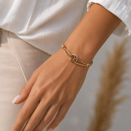 Trilogy Three-Ring adjustable cord bracelet, on the wrist beside the cuff — fashion accessory Dubai