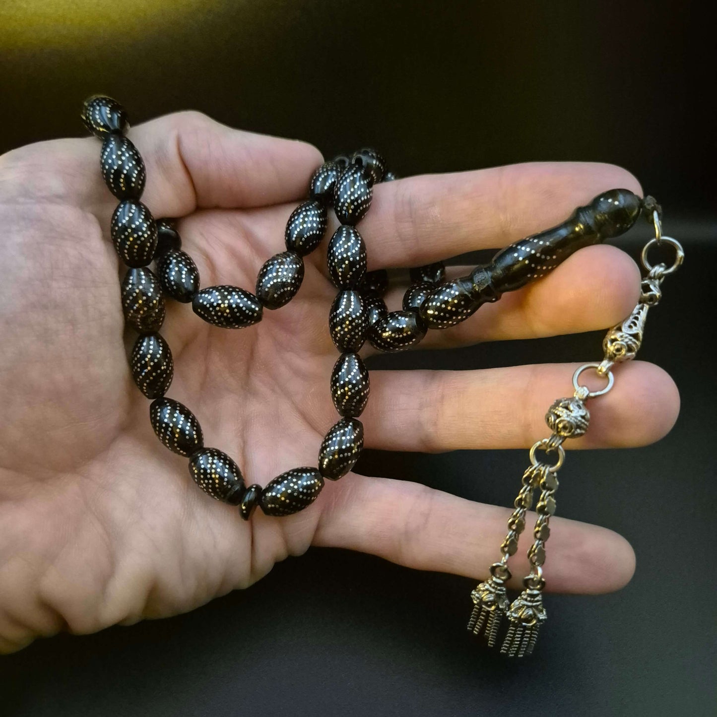 Riverflow Yusur tasbih, detail of the tassel's silver work — rare yeser wood beads