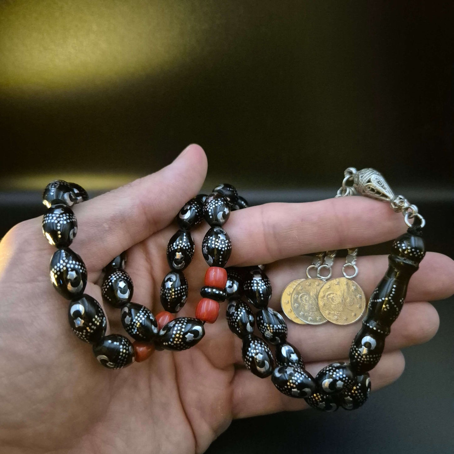 Genuine Yusur Crescent & Moon masbaha, the tassel coiled beside the strand — rare yeser wood beads