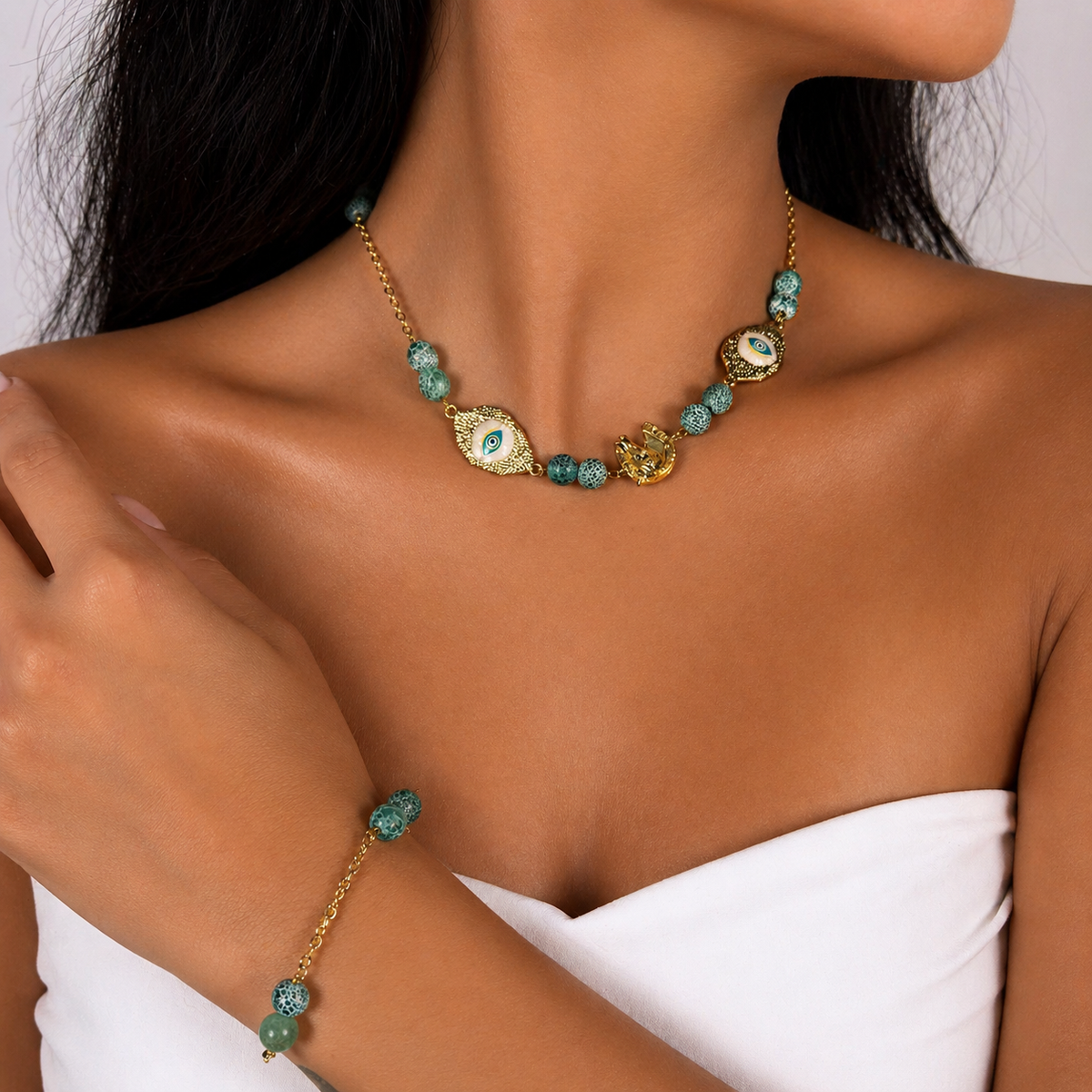 Sterling silver, gold-plated, finished by hand. Each piece carries its own symbol and stone.