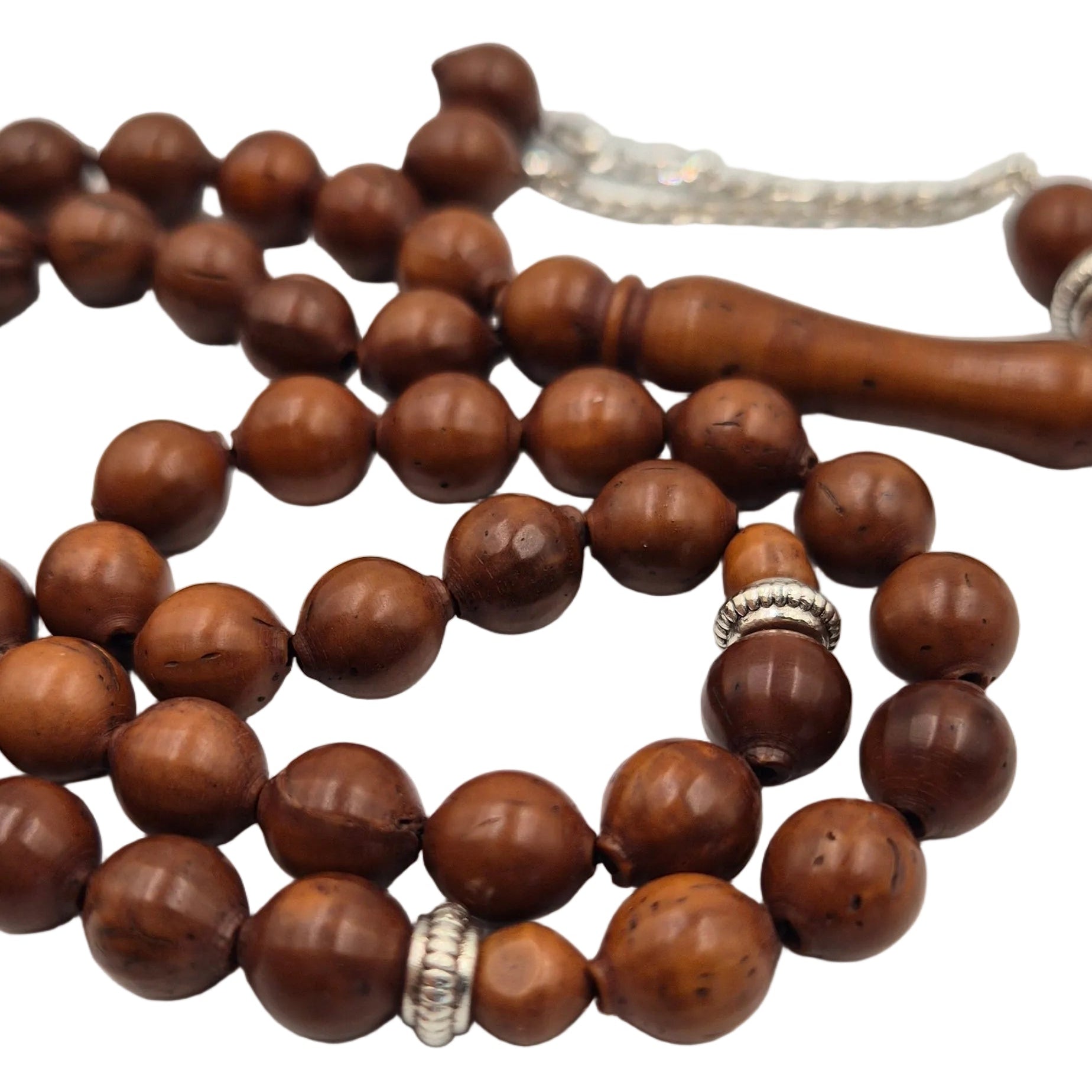 Wooden beaded necklace with silver accents on a light gray background