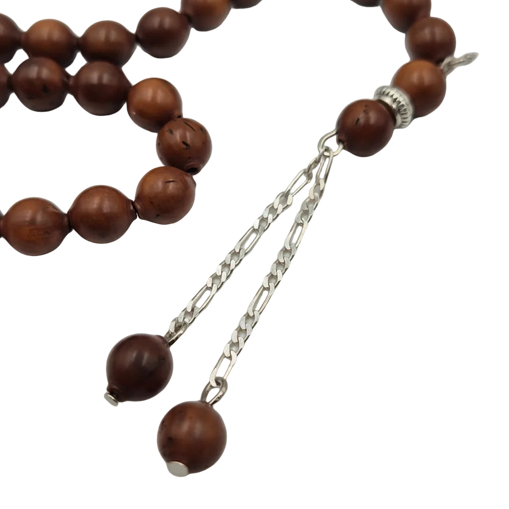 Wooden rosary with silver chain on a light gray background
