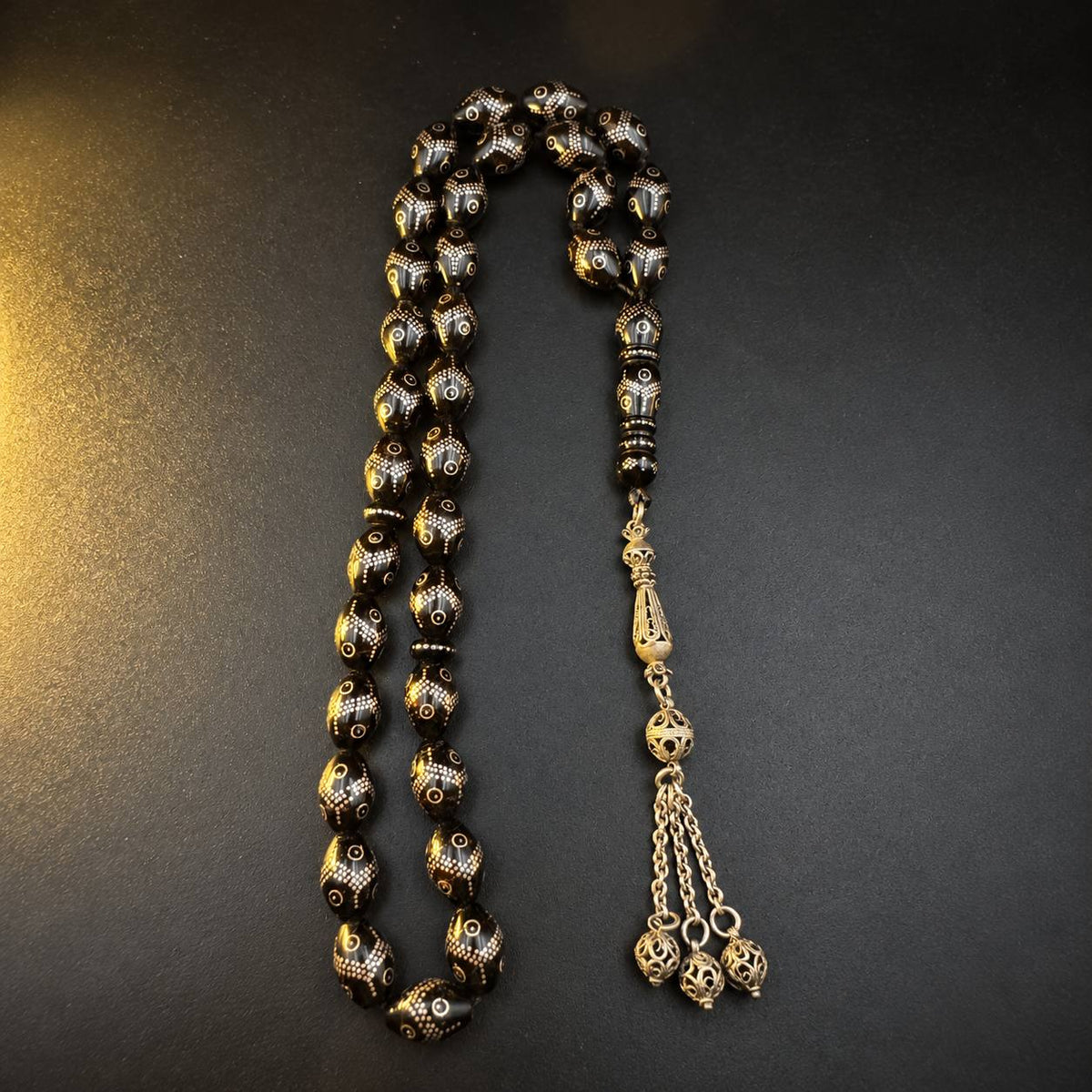 Trellis Yeser black coral mesbah, 33 beads inlaid with silver dot trellis and a three-coin silver tassel — buy yusur beads UAE
