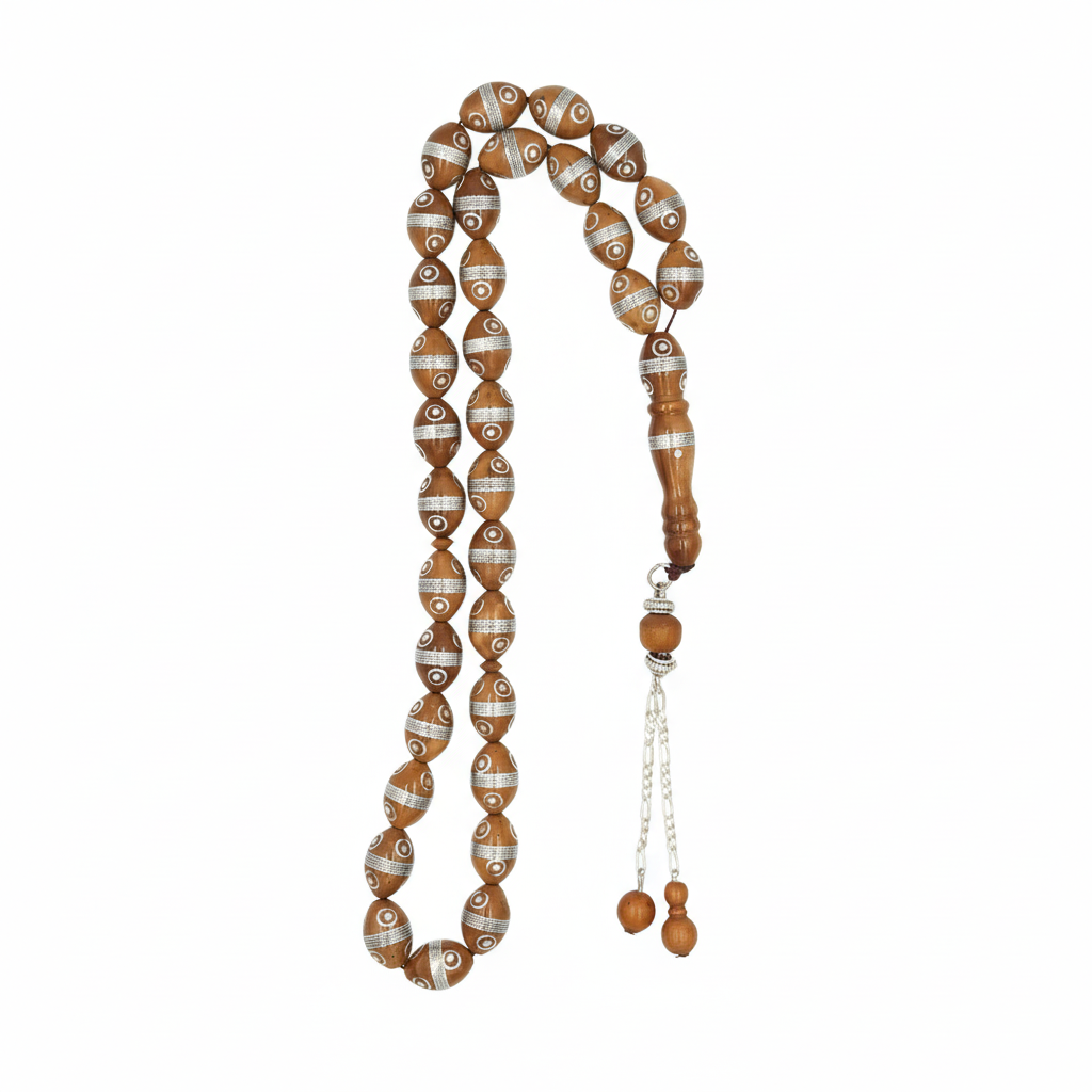 circle of protection and focus. Carved from the resilient Narjil (Coconut) Shell, this tasbih combines organic warmth with metallic precision. Each bead is inlaid with striking Silver-Tone "Orbit" Rings