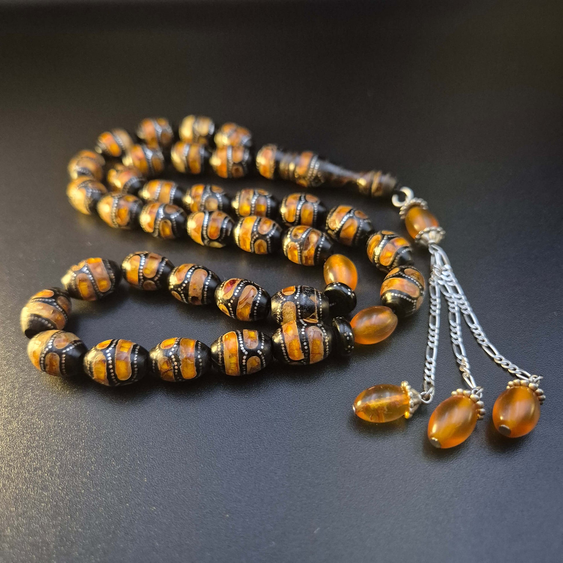 Kahraman Yusr tasbeeh, close detail of natural amber accents in silver inlay — buy yusur wood beads UAE