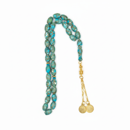 Captivating Azure Essence: A mesmerizing display of vibrant turquoise hues, reminiscent of deep ocean waters, evoking a sense of immediate calm and regal beauty crafted with golden copper and set of silver gold coated.

A celebrated talisman for those born in December, this Fairouz Mesbah resonates deeply with the Sagittarius spirit, offering a grounding energy that encourages truth and safeguards the traveler